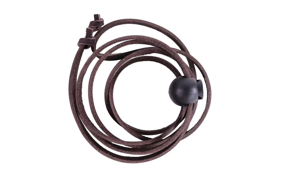 Coiled brown leather strap on a white background