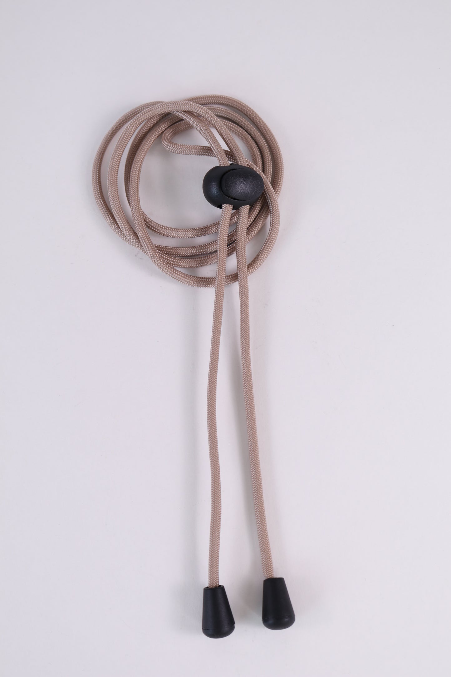 Beige lanyard with black ends and button on a white background