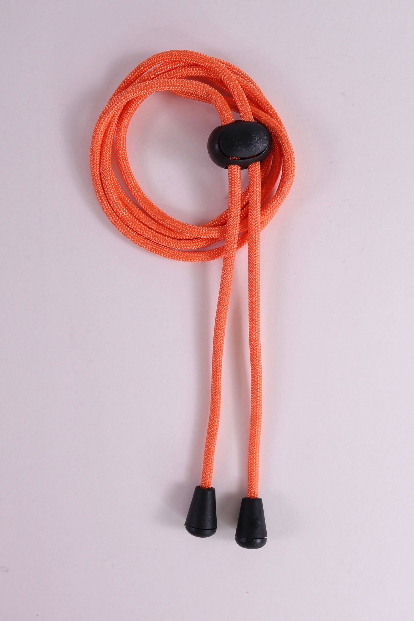 Orange lanyard with black ends on a light gray background