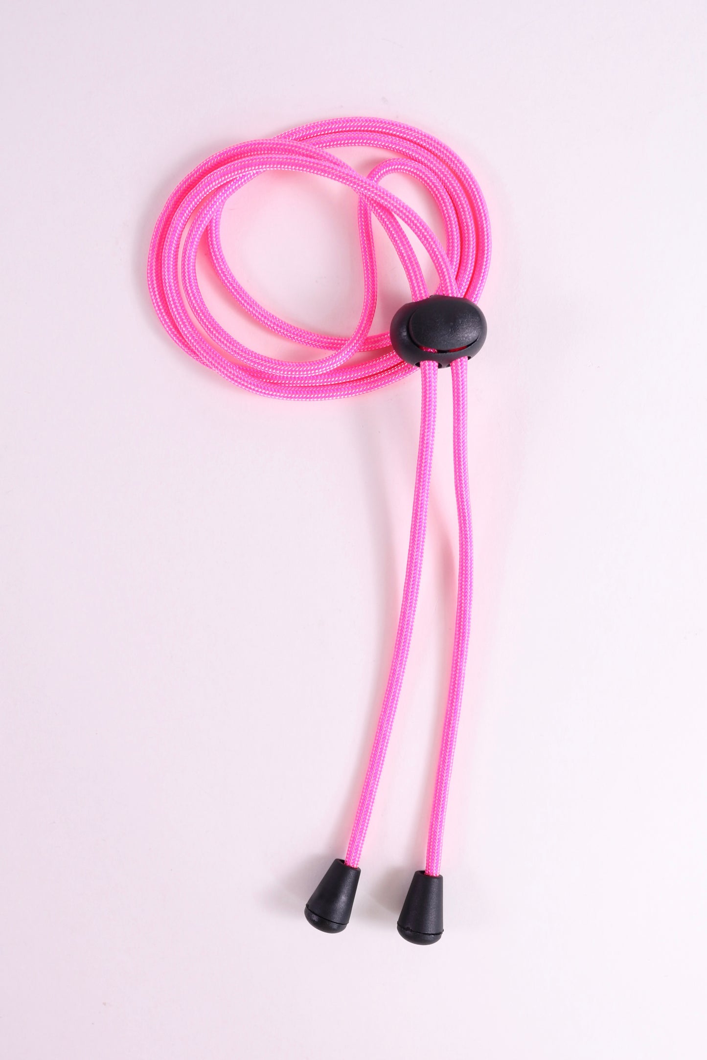 Pink lanyard with black ends on a light pink background