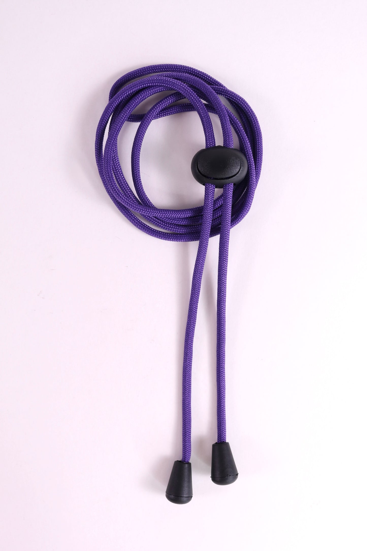 Purple lanyard with a black button on a white background