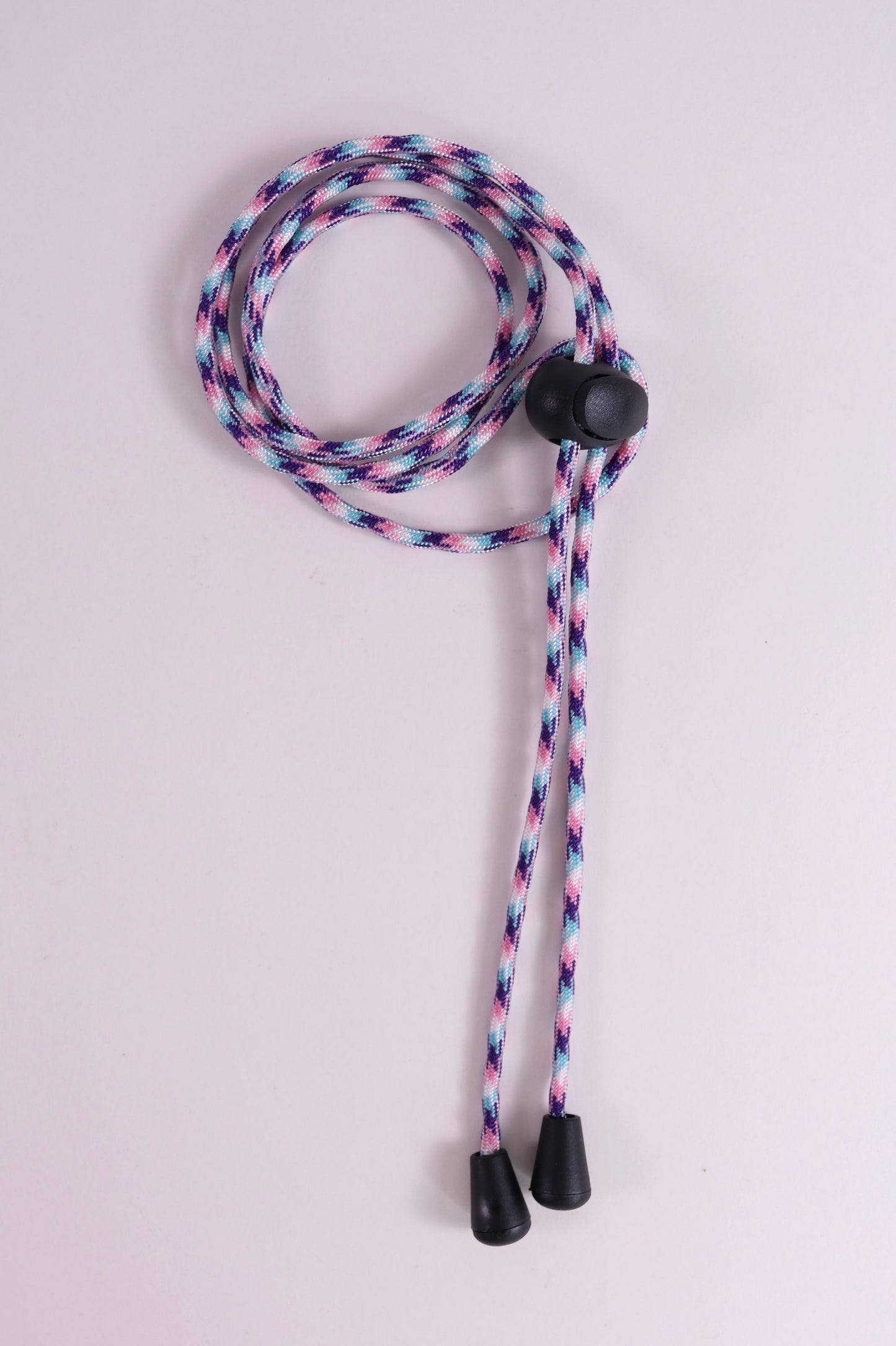 Multicolored braided lanyard with black ends on a light gray background