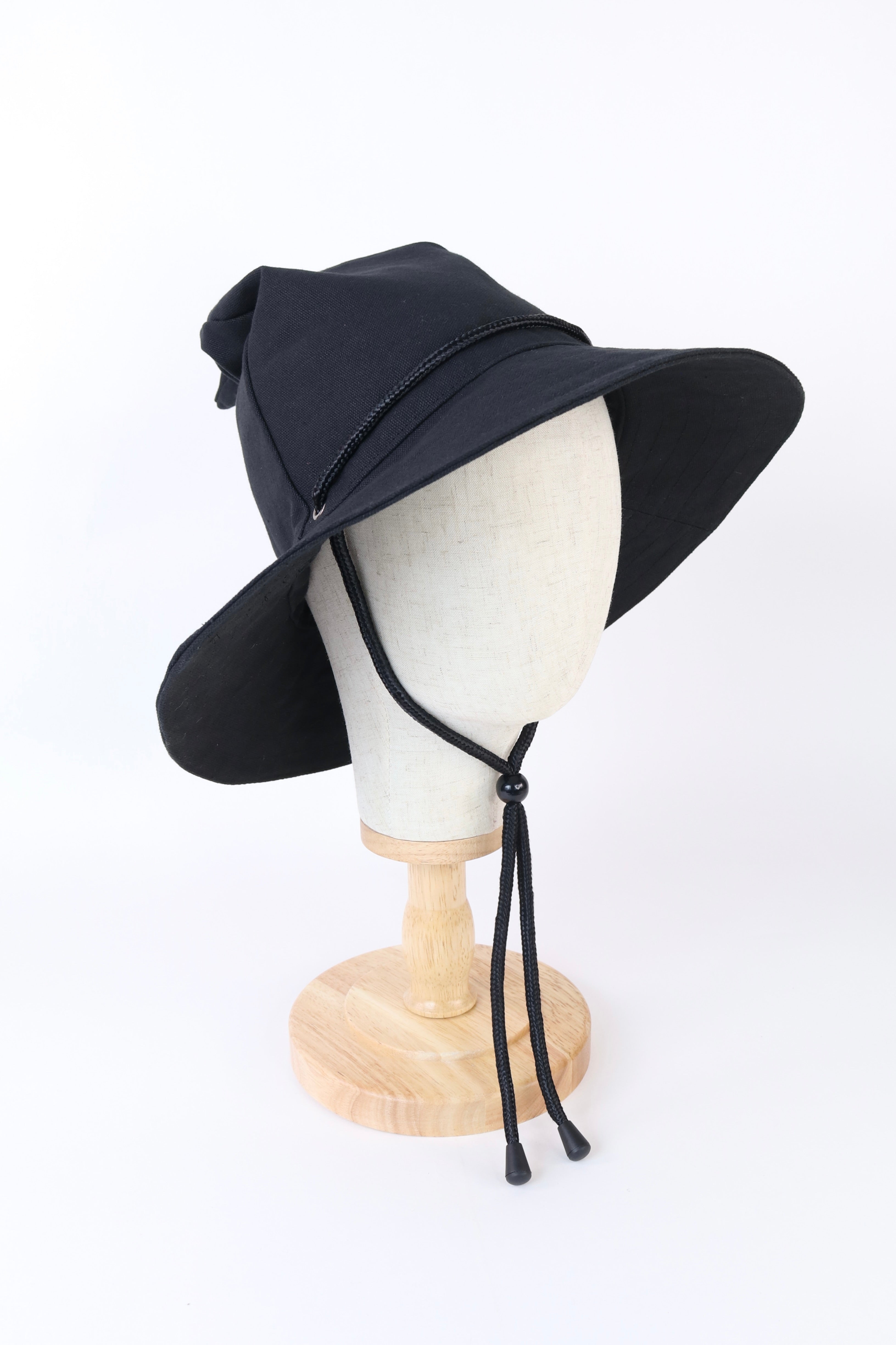 Black wizard bucket hat on a mannequin head against a white background